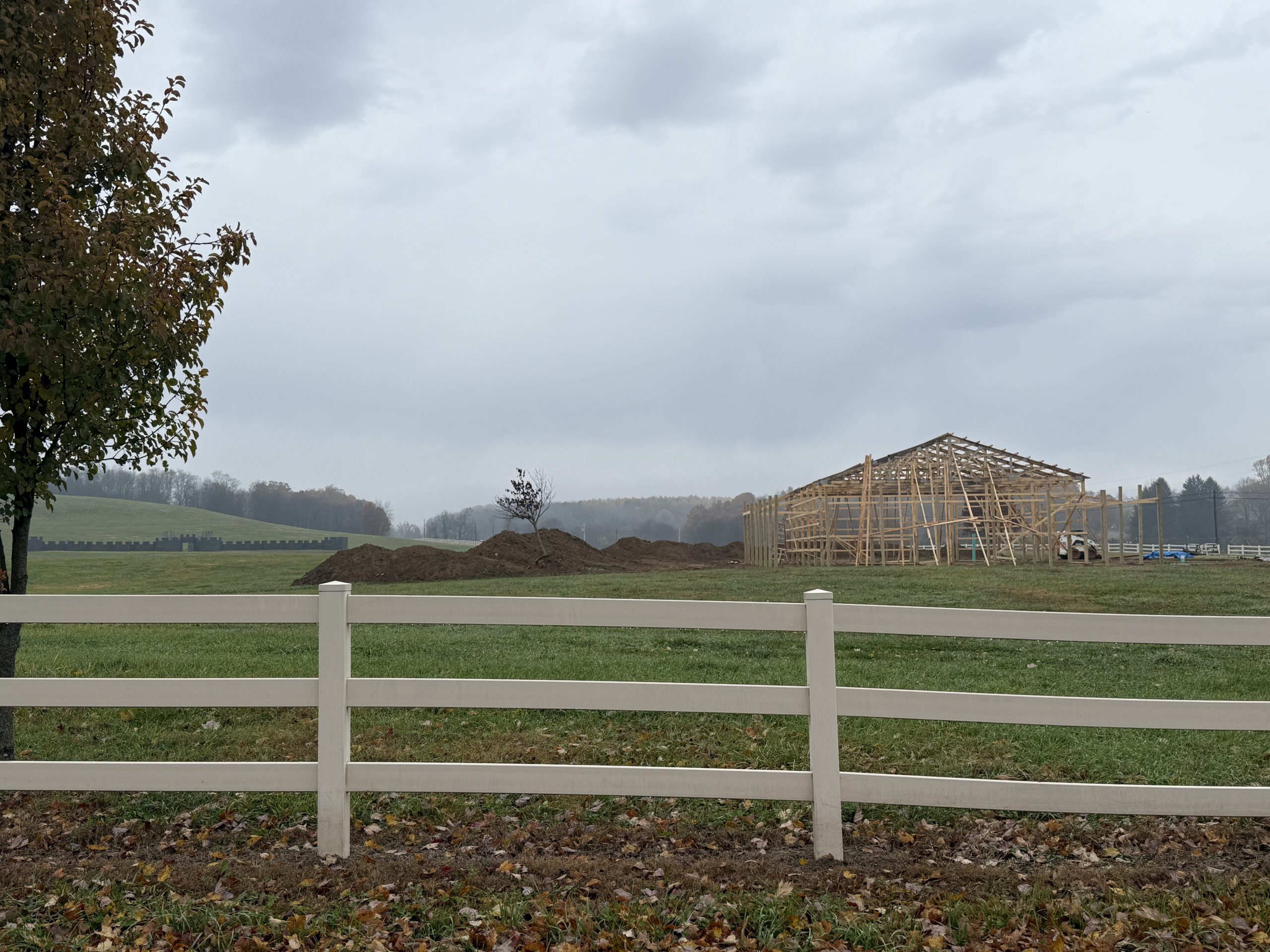 Picture of the new registration building under construction; a wooden frame structure in the middle of construction.